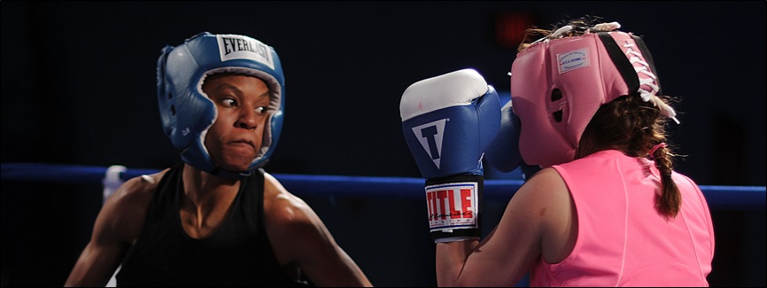 LACKLAND AIR FORCE BASE, Texas (Feb. 15, 2011) Master-at-Arms Seaman Rhonda McGee, left, spars with Patricia Cuevas during an exhibition match in the preliminary rounds of the 2011 Armed Forces Boxing Championship. Competitors from each branch of service square off Feb. 15 through 18 and the action will be televised on the Pentagon Channel. (U.S. Navy photo by Mass Communication Specialist 2nd Class Elliott Fabrizio/Released)