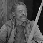 A former slave displaying a horn used to call slaves