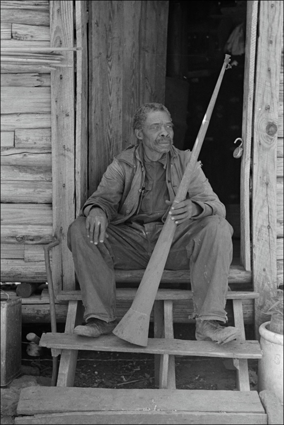 A former slave displaying a horn used to call slaves