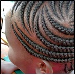 A Dragon claw hairstyle grips a Ugandan girl's fancy for a fashionable do