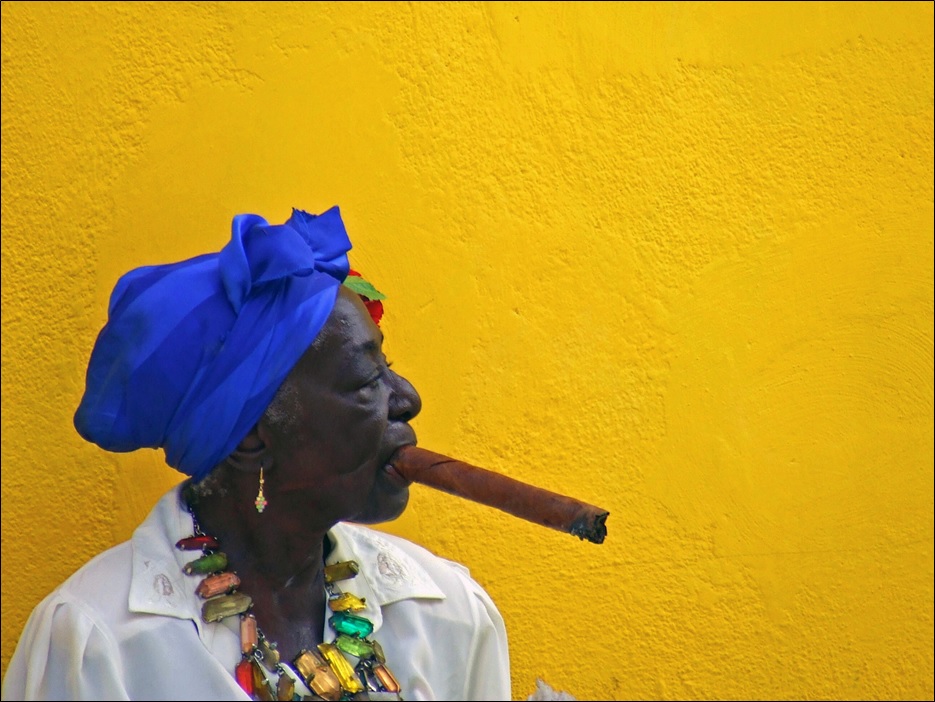 A lady smokes her cigar in the Vieja district of Havana, Cuba