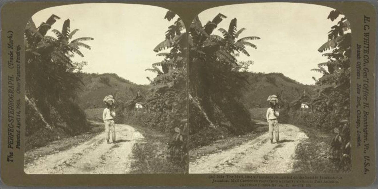 The Mail, like all burdens, is carried on the head in Jamaica. -- A Jamaican mail carrier en route from a country station to Port Antonio