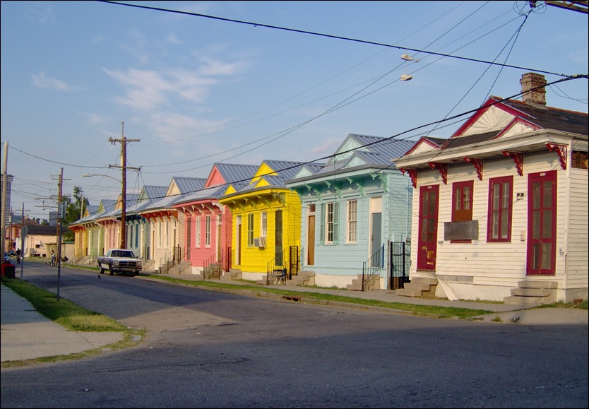 Row of brightly painted "shotgun double" style houses in New Orleans.