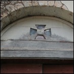 An old door with a wooden arched transom