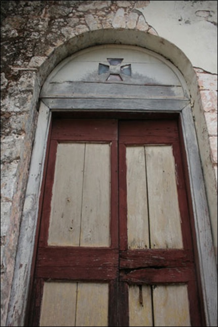 An old door with a wooden arched transom