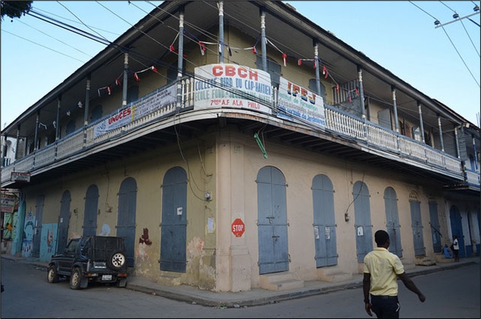 Two-story corner building with wrap around balcony